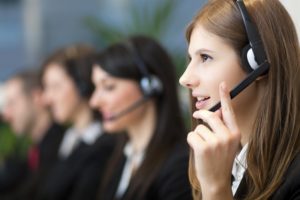 a woman answers a call on her headset