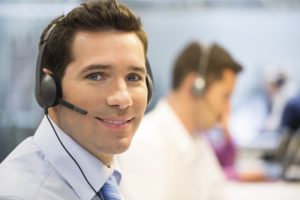 A man wears a headset at a live answering service
